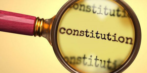 Examine and study constitution, showed as a magnify glass and word constitution to symbolize process of analyzing, exploring, learning and taking a closer look at constitution, 3d illustration
